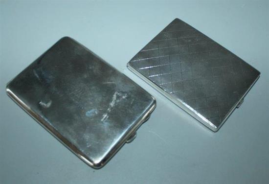 A silver cigarette case and a white metal cigarette case